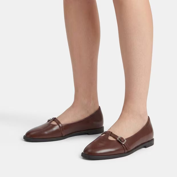 Brown leather ballerina pumps on feet, square buckle strap, low block heel