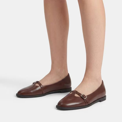 Brown leather ballerina pumps on feet, square buckle strap, low block heel