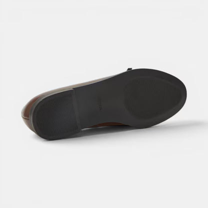Brown ballerina pump outsole with textured grip and low block heel