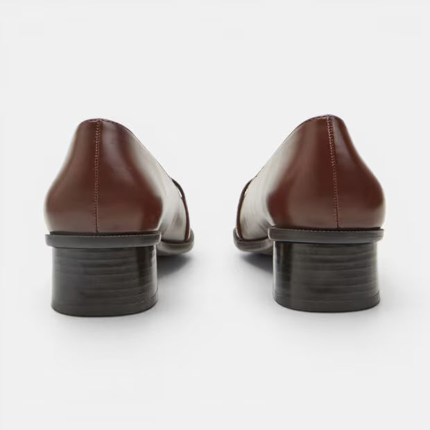 Brown leather block heel pumps, rear view with stacked dark heel and stitching.