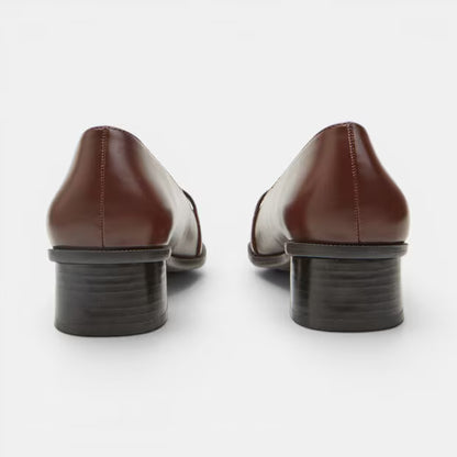 Brown leather block heel pumps, rear view with stacked dark heel and stitching.