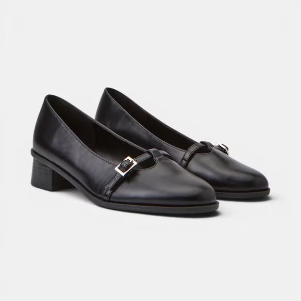 Pair of black leather pumps showing square toe and side buckle closure