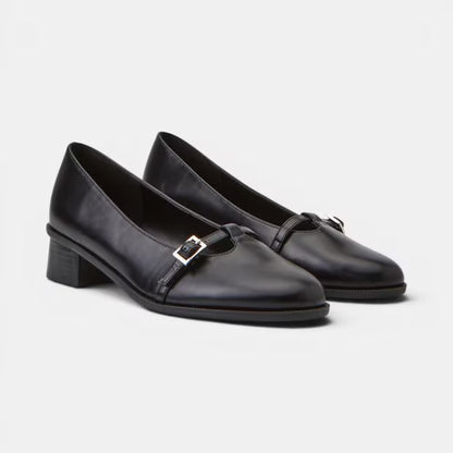 Pair of black leather pumps showing square toe and side buckle closure