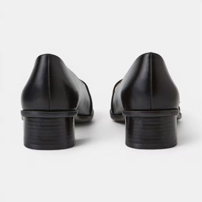 Back view of black leather block-heel pumps with low stacked heel