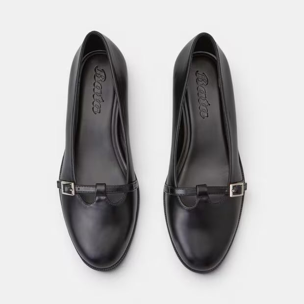 Top view of black leather loaf-style pumps with side buckle strap