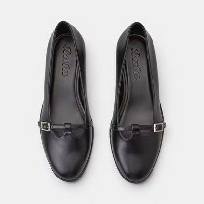 Top view of black leather loaf-style pumps with side buckle strap